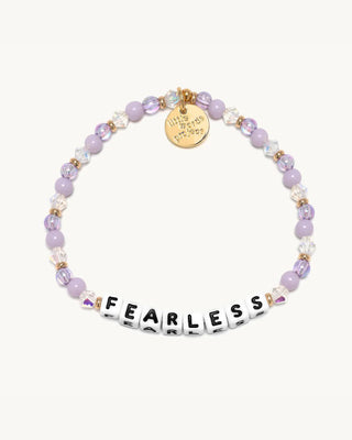 Bracelet with purple beads and letter tiles spelling 'FEARLESS' on a white background