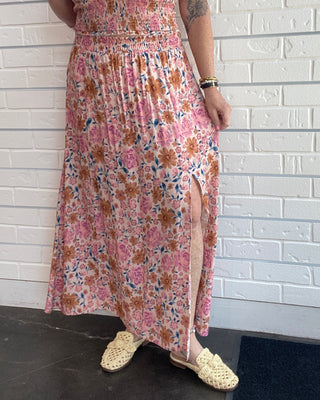 Women's multicolor floral midi skirt with a pintuck waist, side slit, flowy silhouette, and pull-on design.
