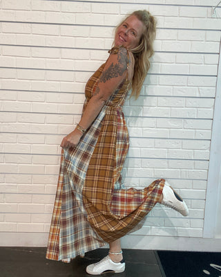 A flowy fall maxi dress with warm plaid, adjustable straps, smocked back