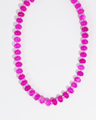 Necklace with pink and purple beads on a white background