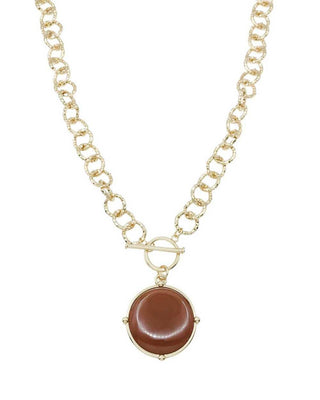 Necklace with a brown circular pendant on a gold chain against a white background