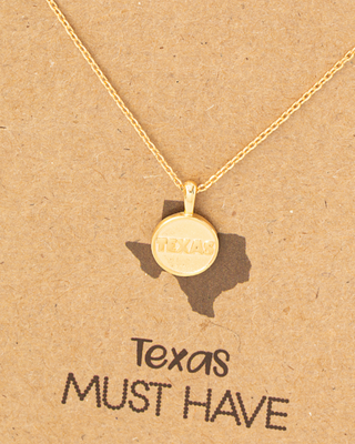 Gold necklace on a 'Texas Must Have' card with a heart symbol