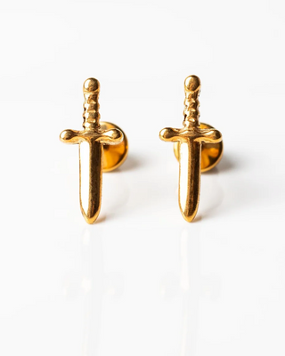 Gold sword-shaped earrings on a white background