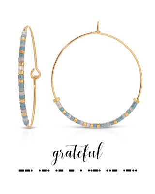 Gold hoop earrings with beaded accents on a white background, featuring the word 'grateful'.