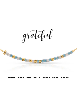 Necklace with blue and gold beads on a white background with 'grateful' text.