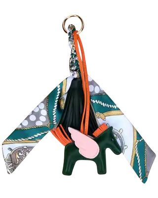Keychain with a patterned strap and green horse-shaped pendant on a white background