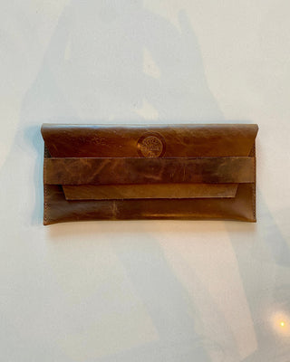 Brown leather clutch bag on a white background