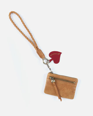Brown wristlet with a red heart charm on a white background