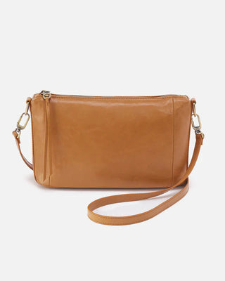 Tan leather crossbody bag on a light beige background