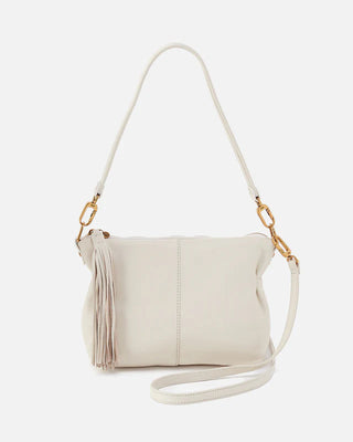 White handbag with gold accents on a light gray background