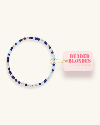 Beaded bracelet with a pink packaging box labeled 'Beaded Blondes' on a white background