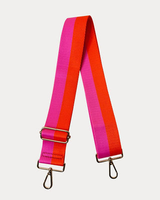 Red and pink striped bag strap with gold hardware on a light gray background