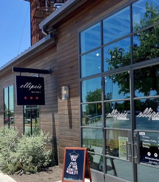 photo outside of ellipsis boutique with the sign in the background