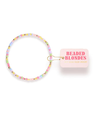Pastel beaded hair tie with 'Beaded Blondes' packaging on a white background