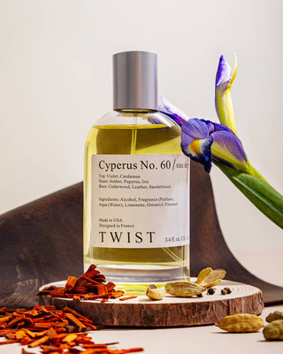 Bottle of Cyperus No. 60 perfume with flowers and spices on a wooden surface