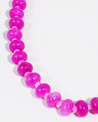 Necklace with pink beads on a white background