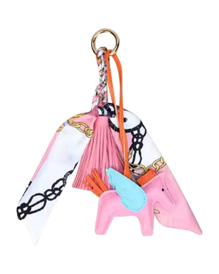 horse-shaped keychain purse charm with tassels on a white background