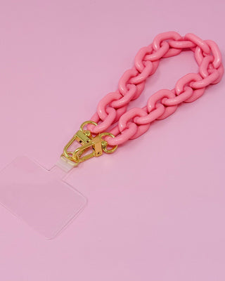 Pink chain strap with gold clasp on a pink background