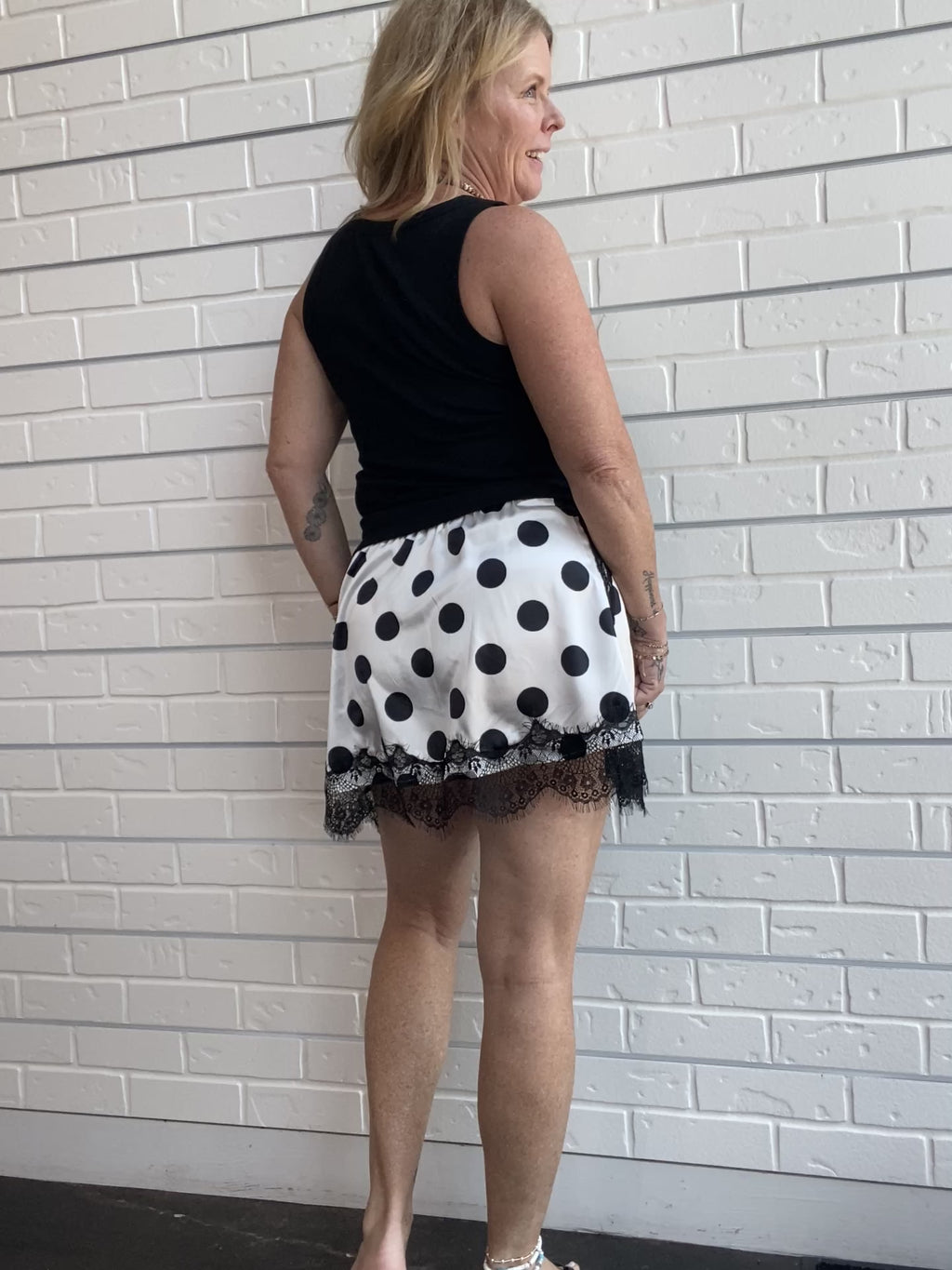 Polka Dot Lace Skirt at Ellipsis Boutique. A flowy satin skirt with a polka dot pattern, stretchy waist, and lace trim.