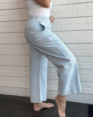Women's railroad stripe carpenter pants with a tie-front waist, tapered leg, side pockets, and ultra-soft cotton denim.