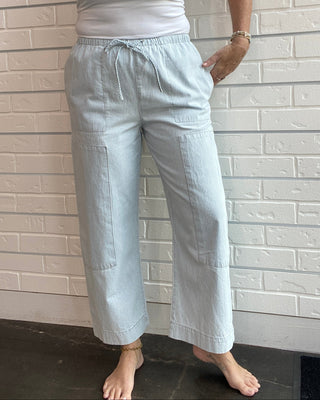 Women's railroad stripe carpenter pants with a tie-front waist, tapered leg, side pockets, and ultra-soft cotton denim.
