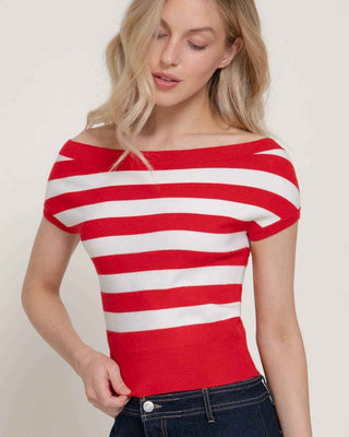 Woman wearing a red and white striped top against a plain background