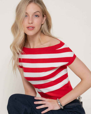 Woman wearing a red and white striped shirt sitting on a white background
