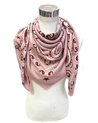 A dusty pink square scarf with a dark red paisley pattern, draped on a white mannequin torso against a white background.