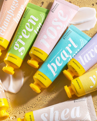 Colorful hand cream tubes with visible brand name on a textured surface