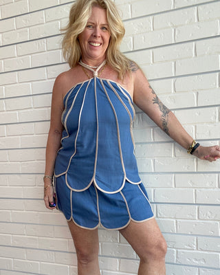 Women's slate blue linen blend halter tank with cream shell panel trim, adjustable knot straps, and a lightweight relaxed fit.