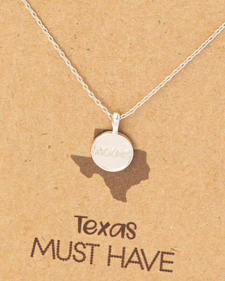 Necklace with a round pendant on a 'Texas Must Have' card