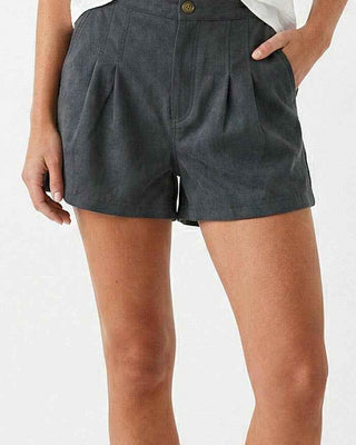 Person wearing gray shorts and brown sandals on a white background
