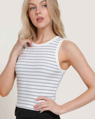 Woman wearing a striped tank top against a plain background