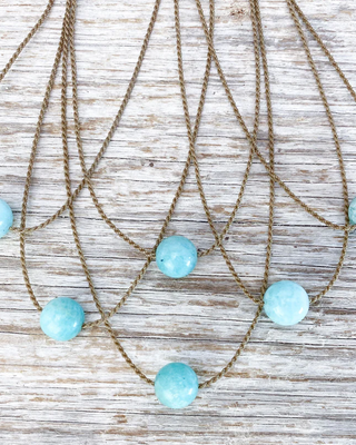 Necklace with blue beads on a wooden surface