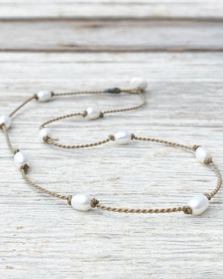 Necklace with pearls on a textured surface