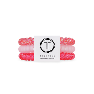 Set of pink and clear hair ties with a Teleties label on a white background