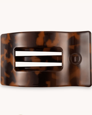 Tortoiseshell belt buckle with a central white stripe on a white background