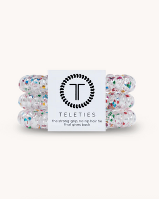Set of colorful hair ties with a Teleties branded card on a white background