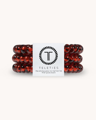 Three brown hair ties with a Teleties label on a white background