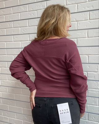 Long Sleeve in a washed burgundy, a textured cotton thermal with a flattering boat neckline and relaxed dolman sleeves.