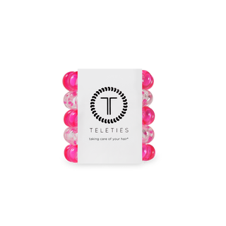 Set of pink hair ties with a Teleties branded card on a white background