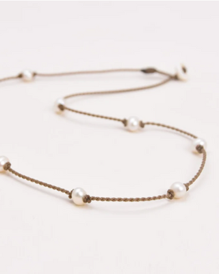 white pearls on rope necklace