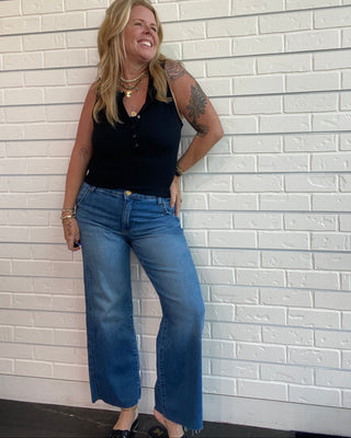 Women's light wash high-rise wide leg jeans with a raw hem, double side seam detail, and soft stretch denim.