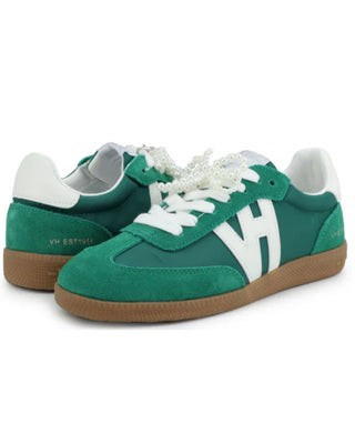 Green sneakers with white laces and brown soles on a white background