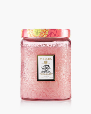Pink Voluspa candle jar with decorative lid on a white background