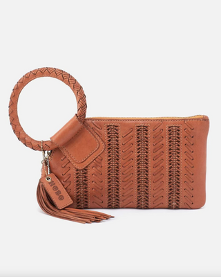 Brown woven clutch with a tassel on a white background