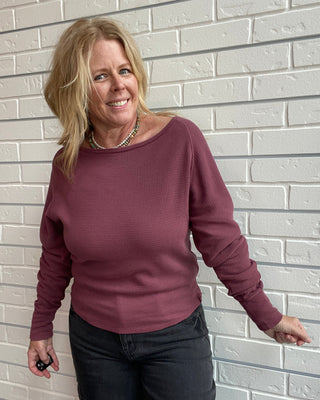 Long Sleeve in a washed burgundy, a textured cotton thermal with a flattering boat neckline and relaxed dolman sleeves.