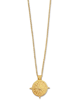 Gold necklace with a circular pendant on a white background