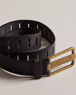 Black belt with a gold buckle on a light gray background