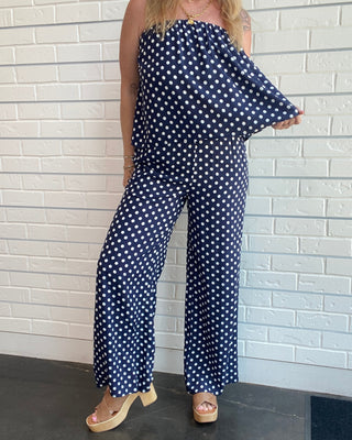Women's navy and white polka dot wide-leg trousers with a smocked waistband, pull-on fit, front pockets, and a relaxed drapey silhouette